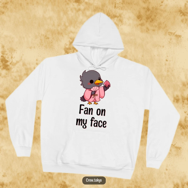 Funny hoodie graphic featuring a playful crow in a pink kimono, balancing a small fan on its beak.